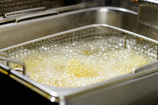 Preparation in a deep fryer. Fresh Falafel balls fries in hot fat in a deep fryer, close-up