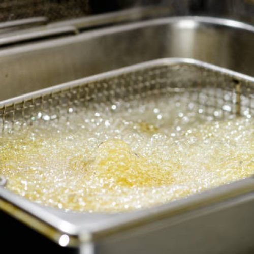 Preparation in a deep fryer. Fresh Falafel balls fries in hot fat in a deep fryer, close-up